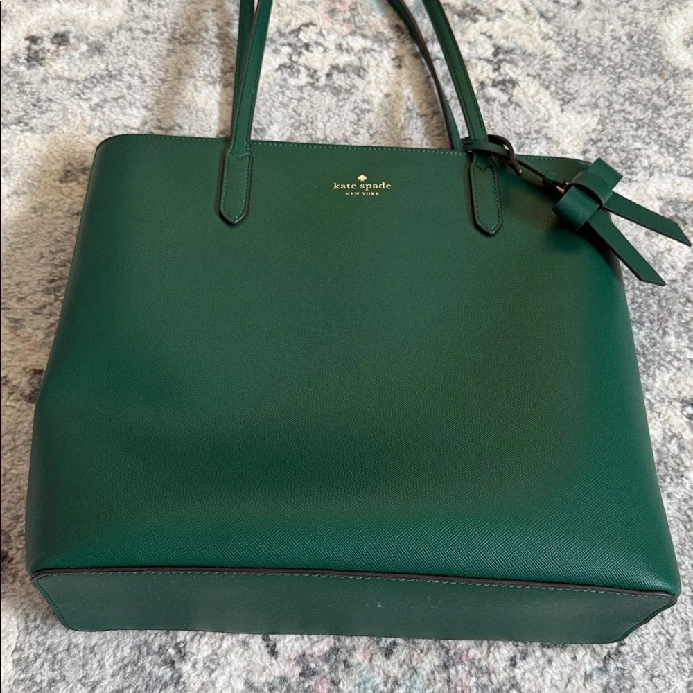 Kate Spade Brynn leather tote bag in the deep jade color with bow charm